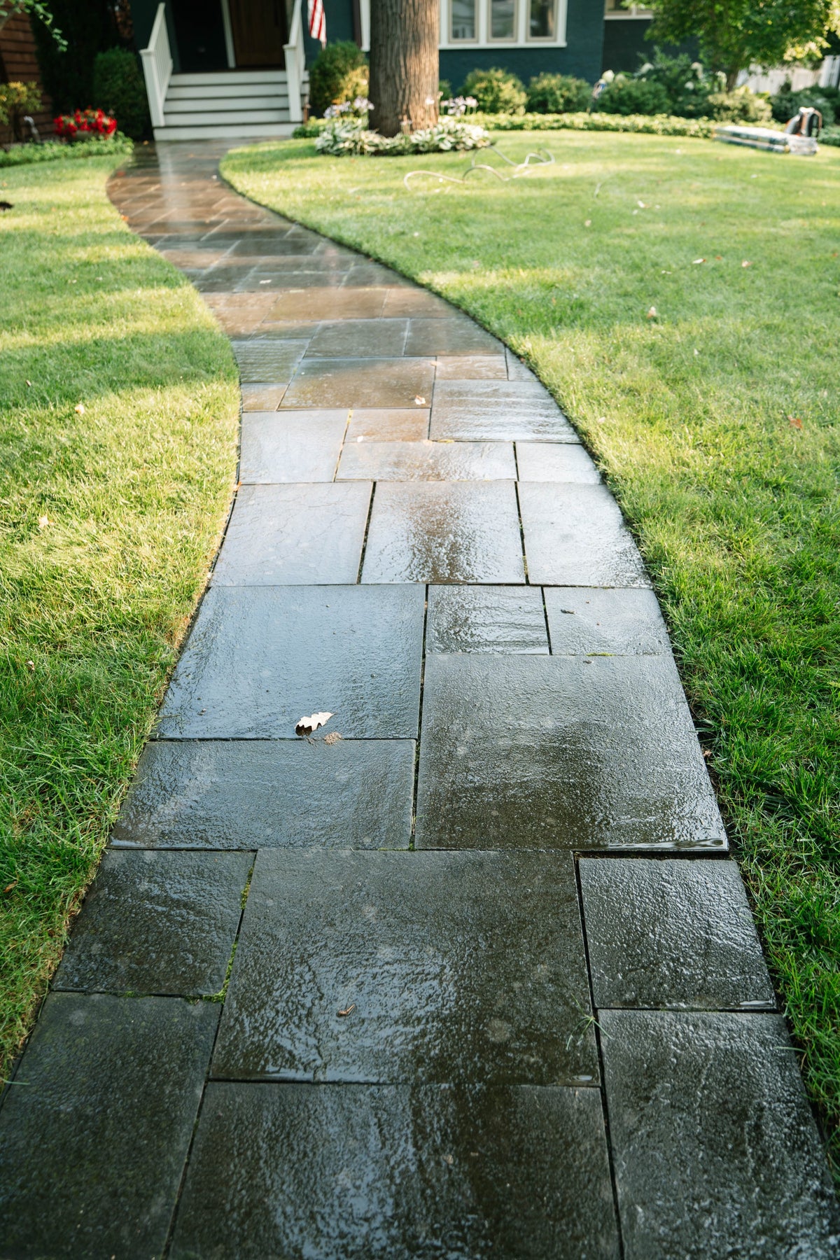 Curved stone walkway leading to a home's front porch
