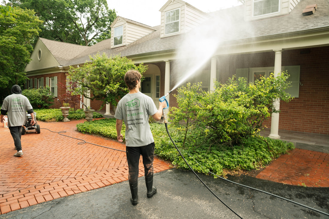 HBP crew washing the exterior of a brick home