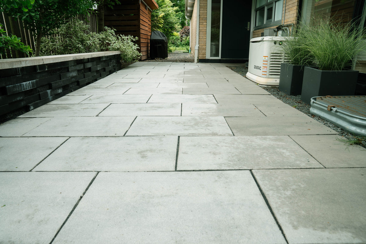 Stone patio beside raised planting beds